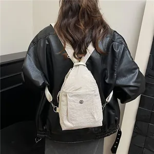 Chic beige nylon crossbody backpack for women showing back-view fit and texture