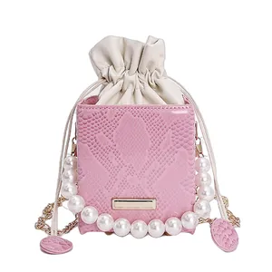 Pink snake print box bag with large pearl handle and gold chain shoulder strap