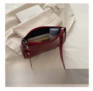 Deep red patent leather baguette bag interior showing capacity for daily essentials