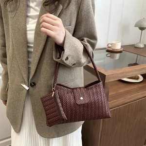 Burgundy woven tote bag with matching coin purse in a stylish lifestyle setting
