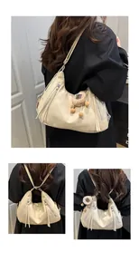 Detailed views of a versatile cream soft leather tote bag with a plush sheep pendant charm