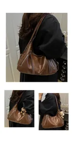 Detail view of dark brown faux leather hobo bag with zipper pockets and tassel accents