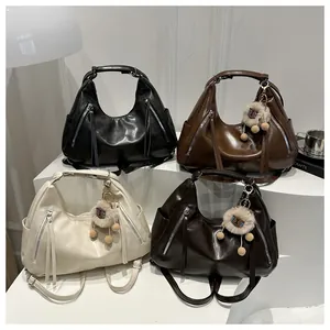 Four colors of soft faux leather hobo bags with tassels and lion keychain pendant