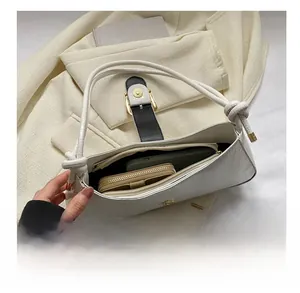 White baguette bag showing spacious interior for phone and wallet with crocodile texture