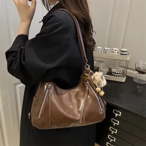 Retro brown soft leather underarm tote bag with silver zippers and plush ball charm