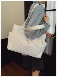Side view of white quilted puffer tote bag with large capacity and double handles