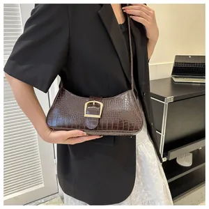Brown faux leather crescent bag with embossed crocodile pattern and gold buckle detail