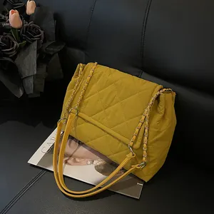 Chic mustard yellow quilted chain shoulder bag with diamond stitching and leather strap