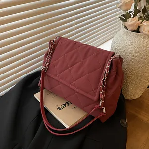 Burgundy quilted shoulder bag with silver chain strap and stylish puffer fabric design