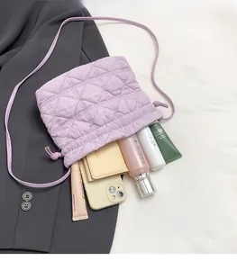 Detailed interior view of a lavender quilted drawstring bag filled with daily essentials