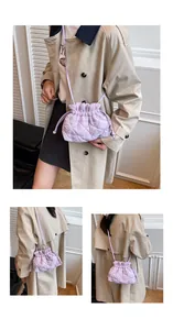 Detailed views of light purple quilted cloud bucket bag with drawstring and crossbody strap