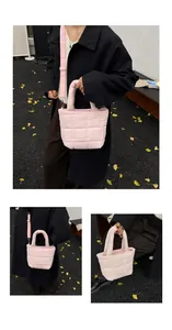 Pink quilted puffer handbag detail showing adjustable wide shoulder strap and soft texture