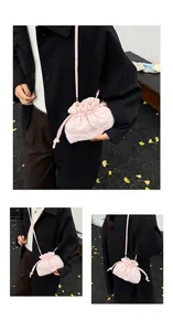 Detailed view of pink quilted cloud bucket bag with drawstring closure and slim strap