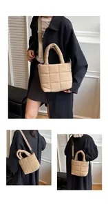Detail of beige quilted shoulder bag featuring grid pattern and adjustable strap