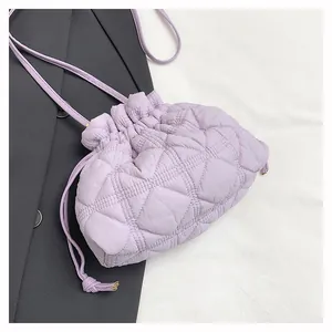 Detailed view of lilac quilted drawstring bucket bag with soft pleated texture