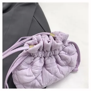 Detail of lavender quilted cloud bucket bag with gold metal drawstring toggle accents