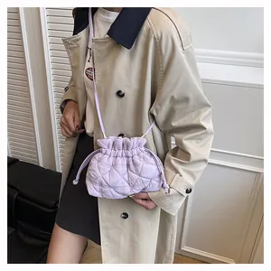 Detail of lavender quilted bucket bag with drawstring closure and slim shoulder strap