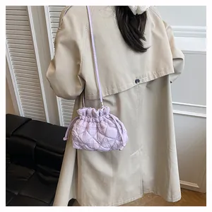 Close-up of light purple quilted drawstring bucket bag with rhombus stitching patterns