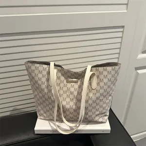 Minimalist large tote bag with M-letter print and cream straps for daily commute