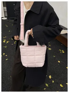 Close-up of pink quilted puffer tote bag with adjustable shoulder strap and soft texture