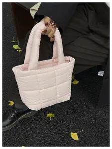 Close-up of quilted pink puffer tote bag with puffy handles and soft nylon texture
