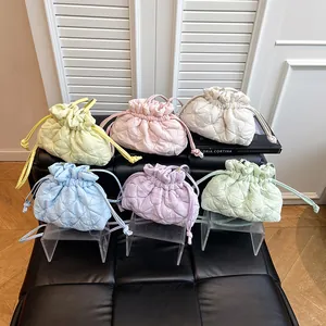 Quilted drawstring bucket bags in six pastel colors featuring a soft cloud-like puff texture