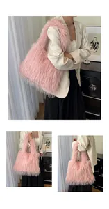 Detail view of pink faux fur shoulder bag featuring soft plush texture and wide strap