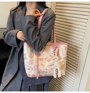 Detail of canvas tote with pink graffiti patterns and a cute white rabbit keychain