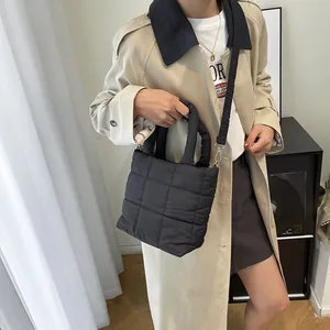 Chic black quilted puffer tote bag with adjustable shoulder strap for women