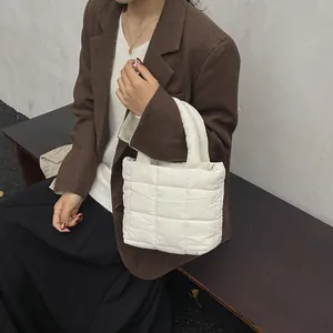 Minimalist white quilted tote bag with checkered stitching and soft handle for women