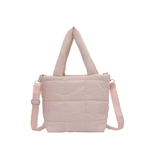 Pink quilted puffer tote bag with adjustable shoulder strap and padded top handles