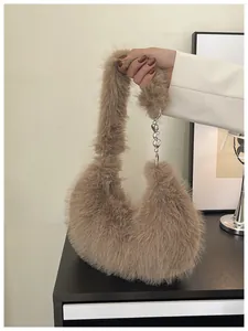 Detailed close-up of brown faux fur hobo bag with silver heart charm and soft texture