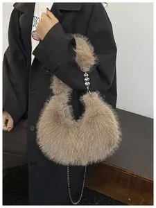 Detail of plush brown faux fur bag with silver heart chain handle and crossbody strap