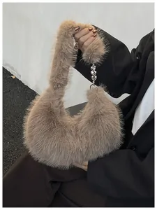 Close-up of khaki faux fur bag with a silver heart charm and chain link details