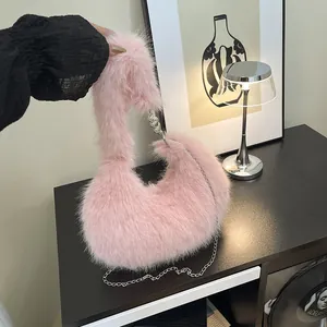 Pink plush crescent faux fur handbag with stylish silver chain strap and fluffy texture