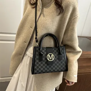 Retro large-capacity monogram tote bag with gold M logo and adjustable shoulder strap