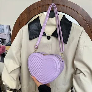 Light purple heart-shaped quilted PU leather crossbody bag with adjustable strap and gold hardware