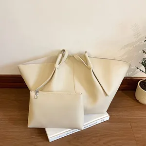 Detail view of beige winged tote bag set with pebble texture and inner zipper pouch