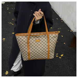 Chic beige tote bag with geometric patterns shown in an autumn street style setting