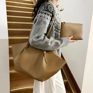 Large brown tote bag and zipper pouch set with wing design and pebble leather texture