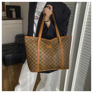 Close-up of brown geometric pattern tote bag with leather handles and large capacity