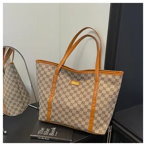 Detailed close-up of a printed tote bag featuring geometric patterns and leather trim