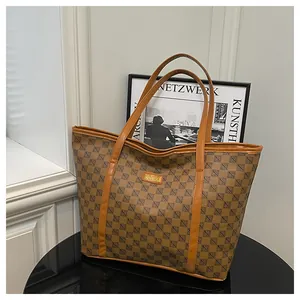 Close-up of printed tote bag featuring vintage geometric patterns and leather handles