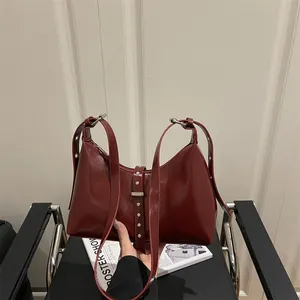 Retro deep red shoulder bag in glossy synthetic leather with silver rivet strap detail