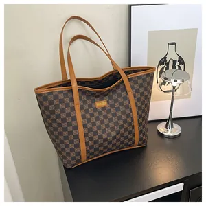 Close-up of brown checkerboard tote bag featuring the yellow Fashion & Bags logo label