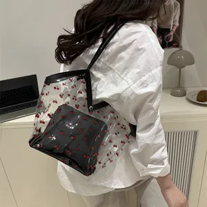 Transparent PVC tote bag with red cherry prints and internal pouch shown in daily use