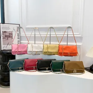 Faux leather shoulder bags with chain straps in nine vibrant colors on display