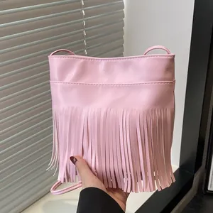 Pink tassel crossbody bag in premium PU leather with minimalist long fringe decoration