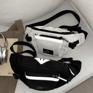 Sporty crossbody chest bag in black and white with reflective strips and adjustable strap