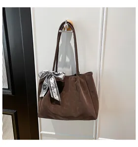 Detail of dark brown frosted leather tote with a stylish decorative Paris silk scarf